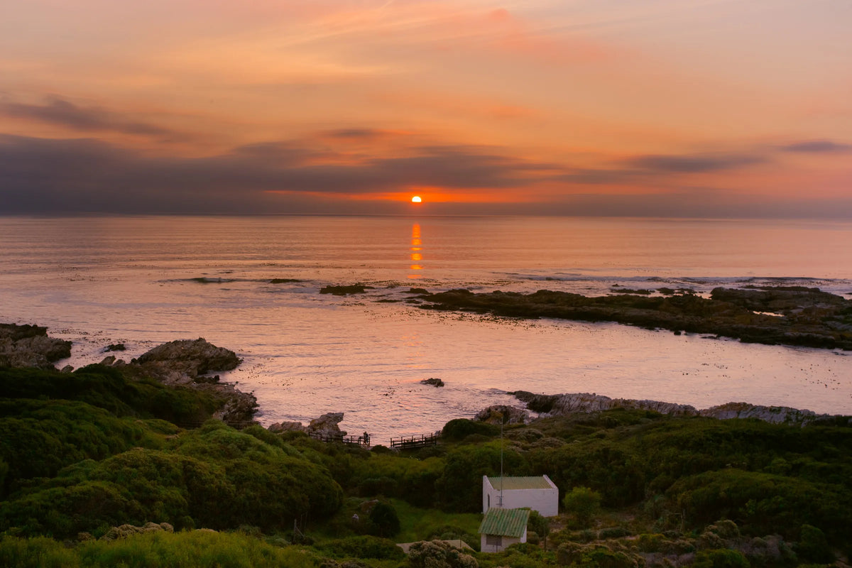 Sunset over the rocky De Kelders shoreline