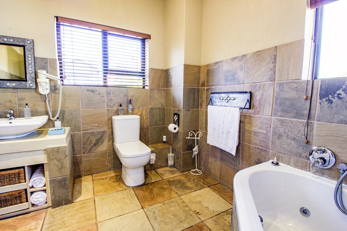 The Hermanus en-suite, with a bath beneath the window