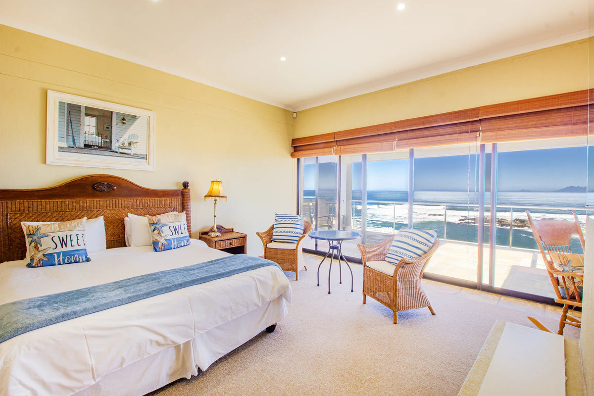 A top-floor bedroom at Whale Waters opening towards the sea